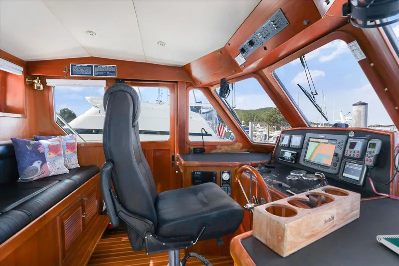 Rogue Yacht Photos Pics Pilothouse interior of 2007 North Pacific NP42, featuring navigation equipment and comfortable seating.