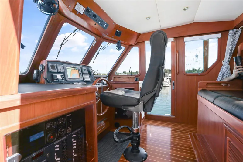 Rogue Yacht Photos Pics 2007 North Pacific NP42 Pilothouse interior with navigation controls and captain's chair.