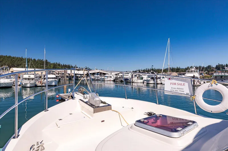 Rogue Yacht Photos Pics 2007 North Pacific NP42 Pilothouse yacht for sale at marina, clear blue sky.