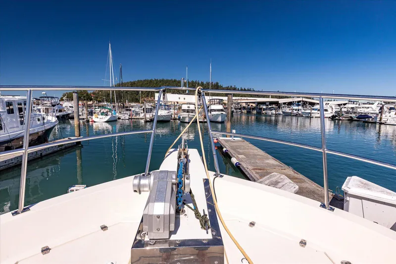 Rogue Yacht Photos Pics 2007 North Pacific NP42 Pilothouse docked in a marina under clear blue skies.