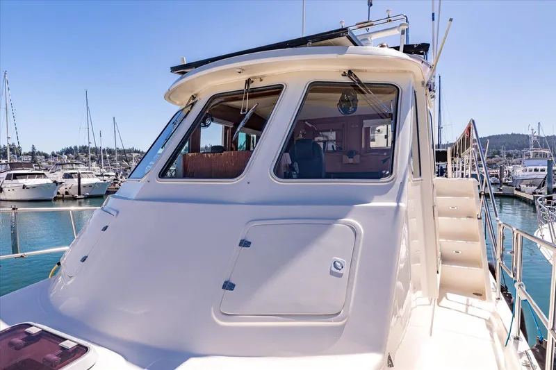 Rogue Yacht Photos Pics 2007 North Pacific NP42 Pilothouse yacht docked in a marina, showcasing its pilothouse and exterior design.