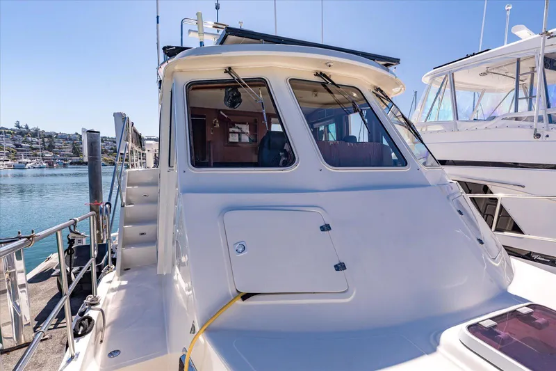 Rogue Yacht Photos Pics 2007 North Pacific NP42 Pilothouse docked, showcasing rear view and pilothouse windows.