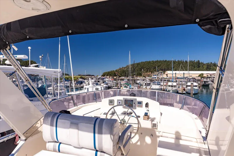 Rogue Yacht Photos Pics Pilothouse view from 2007 North Pacific NP42, overlooking a marina with clear blue skies.