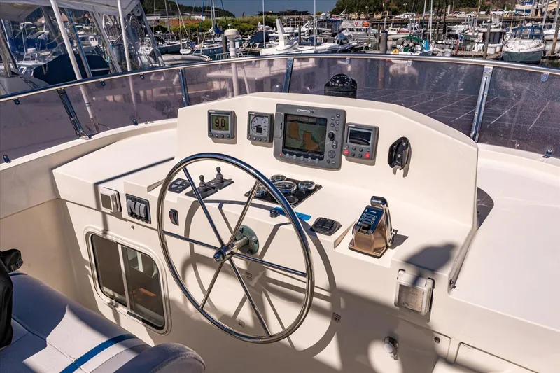 Rogue Yacht Photos Pics Pilothouse of 2007 North Pacific NP42 boat with steering wheel and navigation equipment.