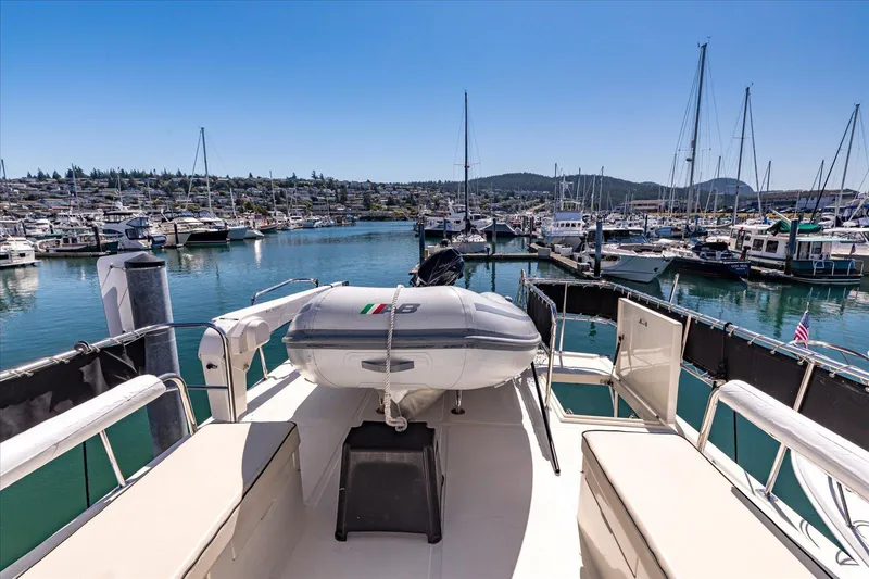 Rogue Yacht Photos Pics 2007 North Pacific NP42 Pilothouse yacht docked in a marina, surrounded by sailboats.