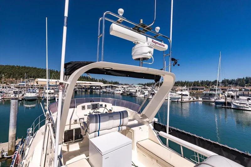 Rogue Yacht Photos Pics 2007 North Pacific NP42 Pilothouse yacht docked in a marina under clear blue skies.