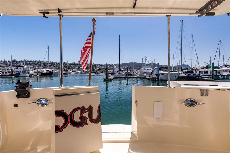 Rogue Yacht Photos Pics 2007 North Pacific NP42 Pilothouse yacht docked in a marina with boats and clear blue sky.