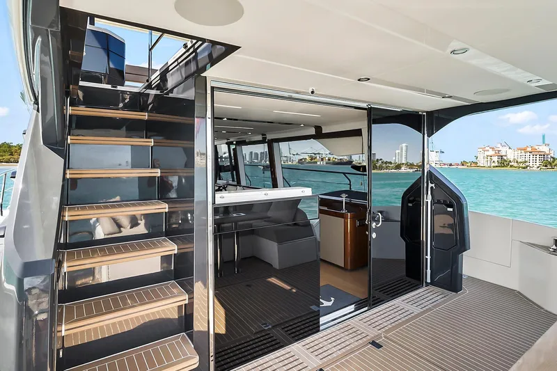 Raw Wave Yacht Photos Pics Luxury 2021 Fairline Squadron 68 yacht interior with staircase and ocean view.