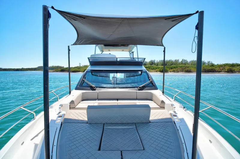 Raw Wave Yacht Photos Pics 2021 Fairline Squadron 68 yacht with sunshade, cruising on clear blue waters.
