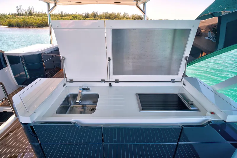 Raw Wave Yacht Photos Pics Outdoor kitchen on 2021 Fairline Squadron 68 yacht with sink and grill, near water.