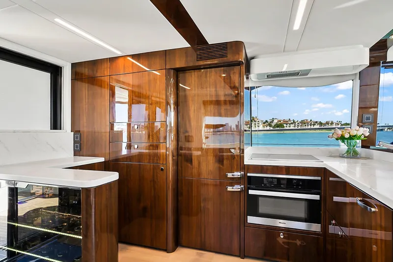 Raw Wave Yacht Photos Pics Luxurious 2021 Fairline Squadron 68 yacht kitchen with modern wood finish and ocean view.