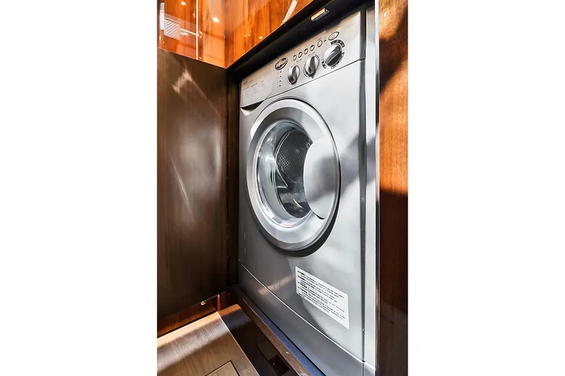 Raw Wave Yacht Photos Pics Washing machine inside 2021 Fairline Squadron 68 yacht, wooden cabinetry.