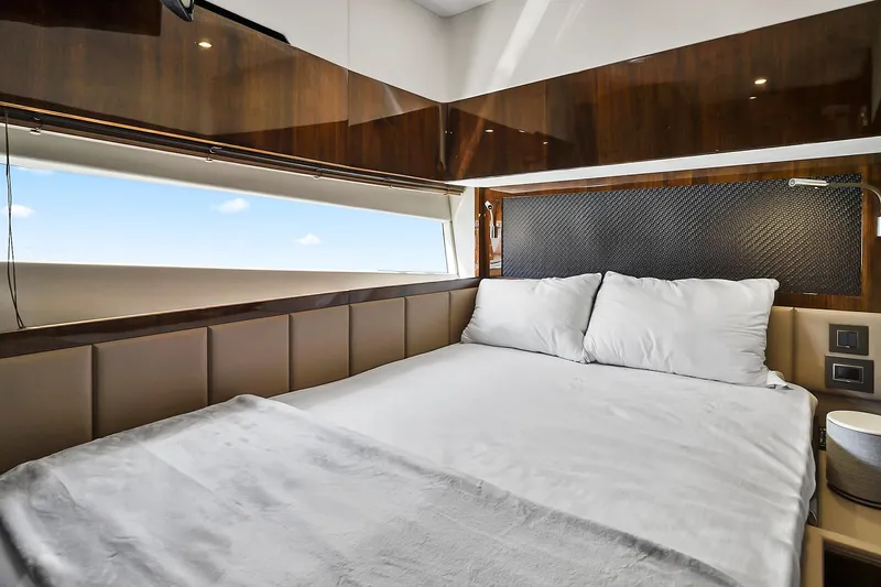 Raw Wave Yacht Photos Pics Luxurious bedroom interior of 2021 Fairline Squadron 68 yacht with elegant wood finishes.