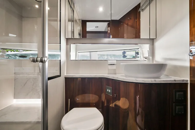 Raw Wave Yacht Photos Pics Luxurious bathroom in 2021 Fairline Squadron 68 yacht with modern fixtures and elegant design.