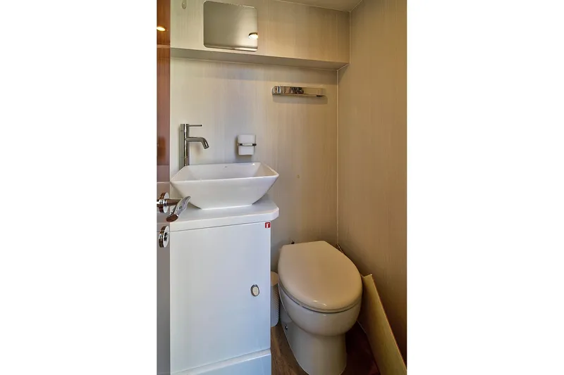 Raw Wave Yacht Photos Pics Modern bathroom in 2021 Fairline Squadron 68 yacht, featuring sleek sink and toilet.