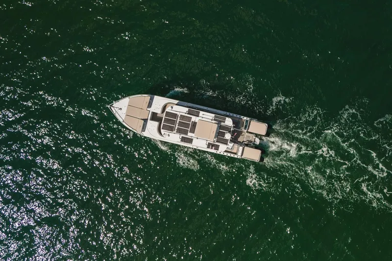  Yacht Photos Pics Aerial view of 2024 YachtCat 41 cruising on open water.