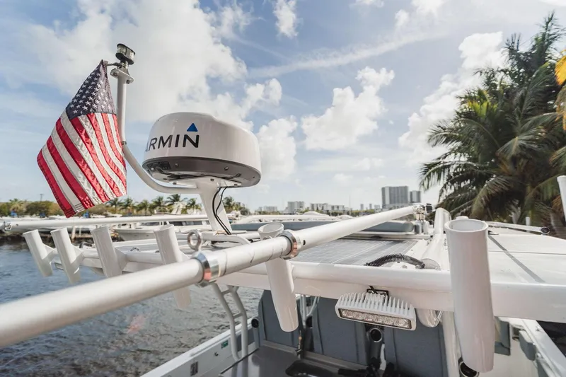  Yacht Photos Pics 2024 YachtCat 41 with Garmin radar and American flag, docked near palm trees and cityscape.
