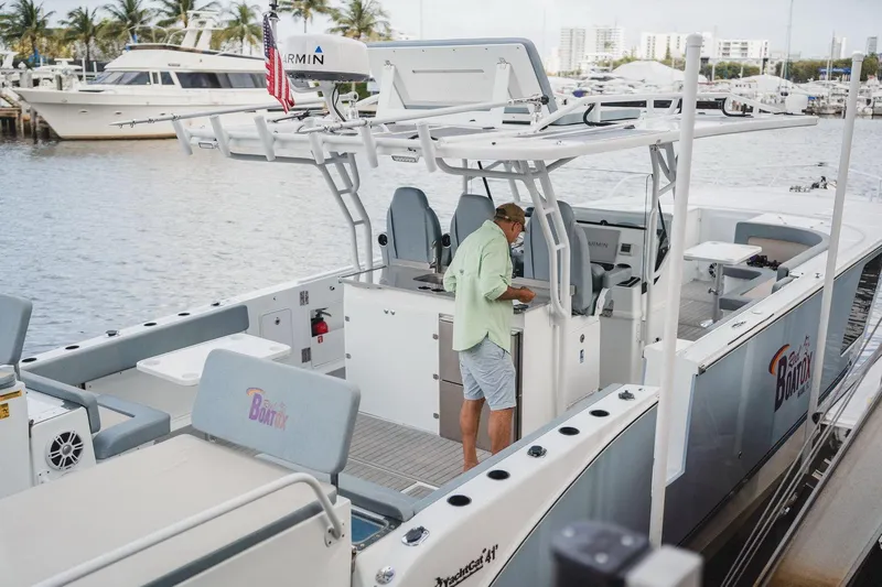  Yacht Photos Pics 2024 YachtCat 41 docked, featuring spacious deck and modern design, with person onboard.
