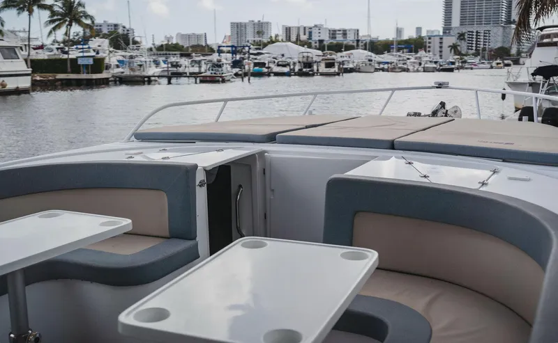  Yacht Photos Pics Luxury YachtCat 41 (2024) interior with marina view, featuring elegant seating and tables.