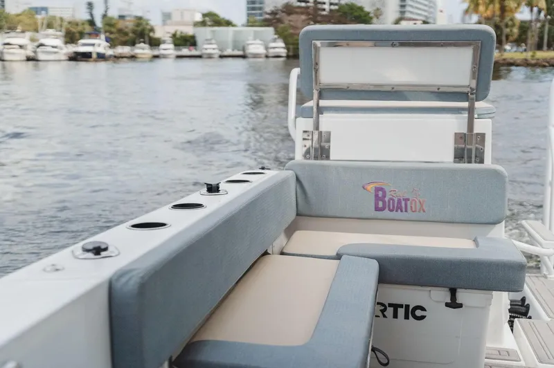  Yacht Photos Pics 2024 YachtCat 41 boat seating area with water view and docked yachts in the background.