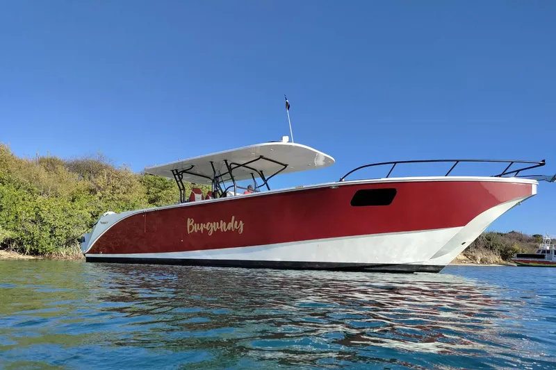  Yacht Photos Pics 2024 YachtCat 41 in water, red and white design, clear blue sky background.