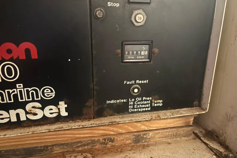 Wonderer Yacht Photos Pics Control panel of a 1987 Bertram 54 Convertible marine generator with hour meter and fault indicators.