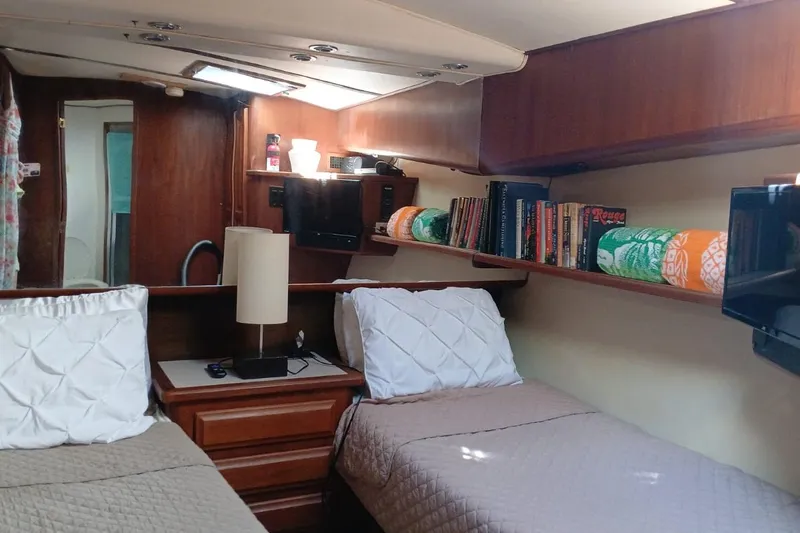 Paloma Yacht Photos Pics Interior of 1991 Viking 57 Convertible yacht with twin beds and wooden shelves.