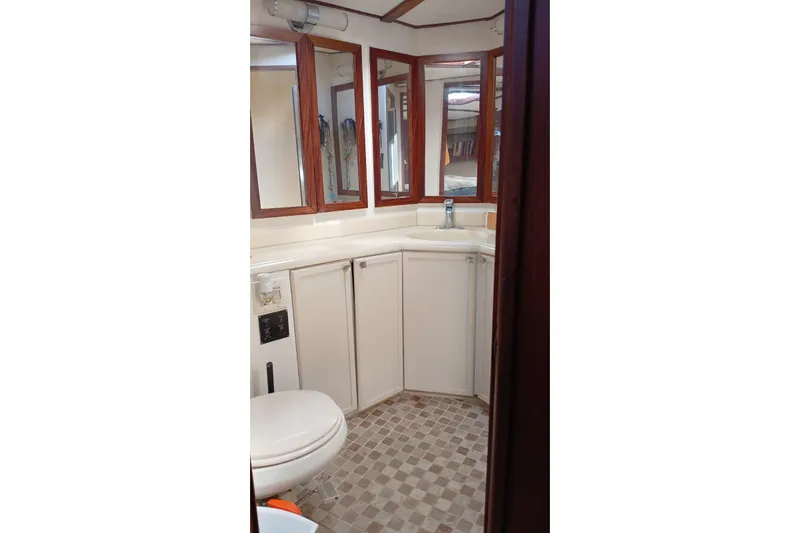 Paloma Yacht Photos Pics Bathroom interior of 1991 Viking 57 Convertible yacht with mirrors and cabinetry.