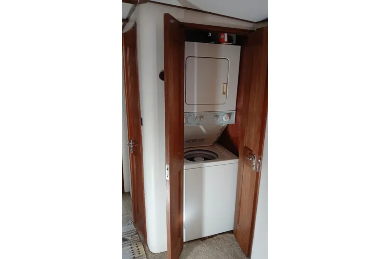 Paloma Yacht Photos Pics Stacked washer and dryer in 1991 Viking 57 Convertible yacht interior.