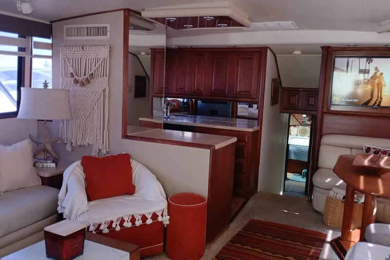 Paloma Yacht Photos Pics Interior of a 1991 Viking 57 Convertible yacht with cozy seating and wooden cabinetry.