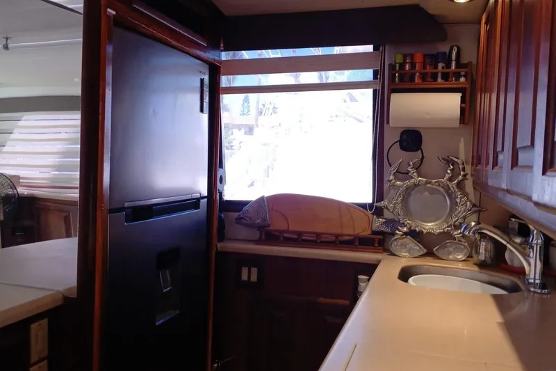 Paloma Yacht Photos Pics Interior of 1991 Viking 57 Convertible yacht kitchen with modern appliances and wooden cabinetry.