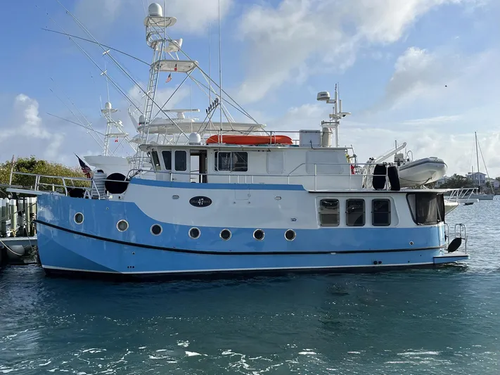 Bazan Yacht Photos Pics 2001 Great Harbour GH47 yacht docked in a marina, blue and white exterior.