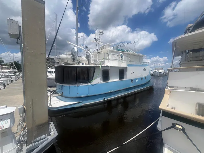 Bazan Yacht Photos Pics Great Harbour GH47 yacht from 2001 docked at a marina under a cloudy sky.