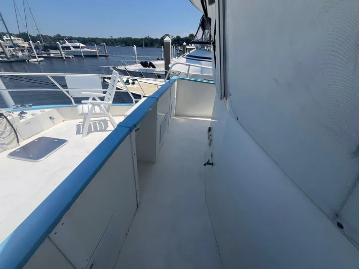 Bazan Yacht Photos Pics 2001 Great Harbour GH47 yacht deck with marina view, featuring white seating and blue trim.