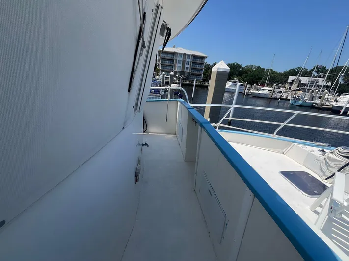 Bazan Yacht Photos Pics Side deck of 2001 Great Harbour GH47 yacht at marina, clear sky, calm water.