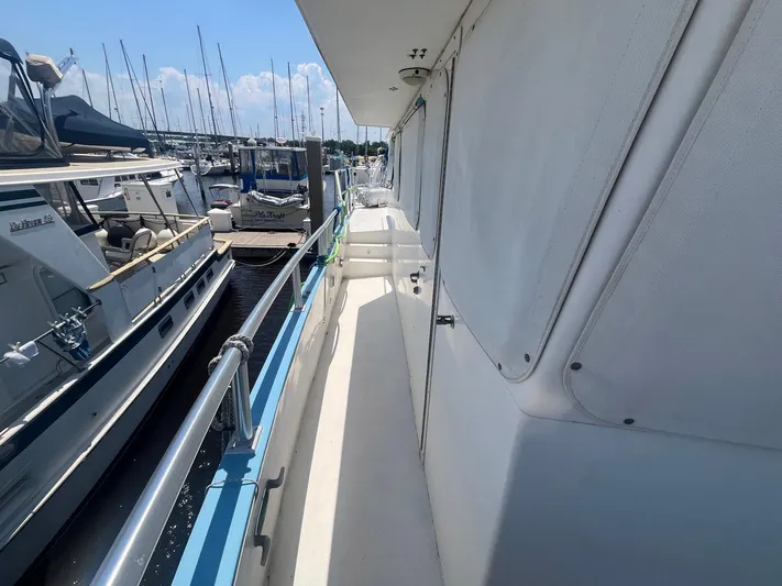 Bazan Yacht Photos Pics 2001 Great Harbour GH47 yacht docked at marina, side view with railings and covered windows.