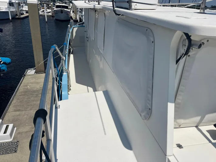 Bazan Yacht Photos Pics 2001 Great Harbour GH47 yacht docked at marina, side view with railing and covered windows.
