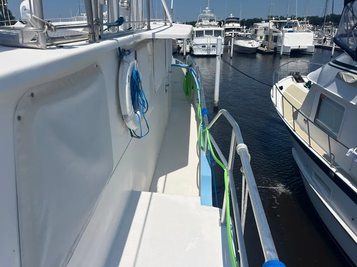 Bazan Yacht Photos Pics Great Harbour GH47 yacht docked at marina, side view with railing and life ring, 2001 model.