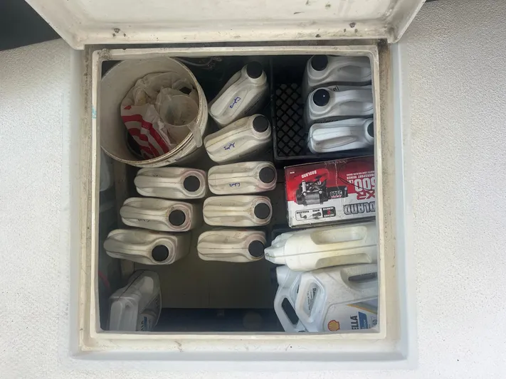 Bazan Yacht Photos Pics Storage compartment with oil containers and a bucket on a 2001 Great Harbour GH47 boat.