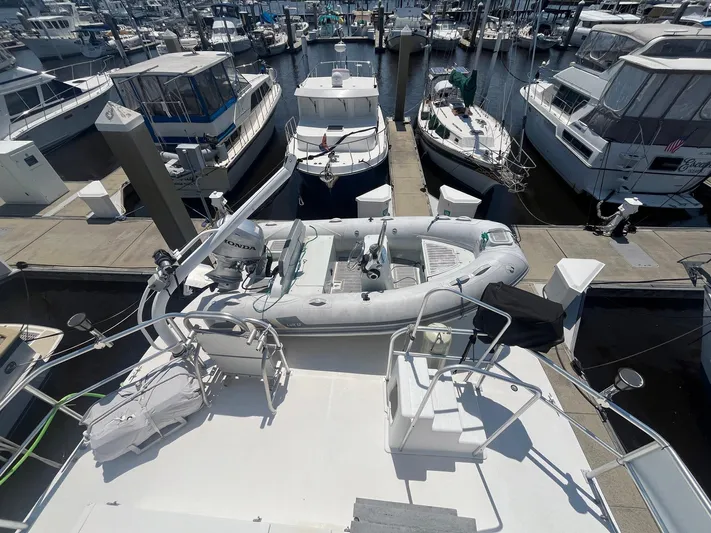 Bazan Yacht Photos Pics Great Harbour GH47 yacht docked with inflatable boat on deck, marina background, 2001 model.