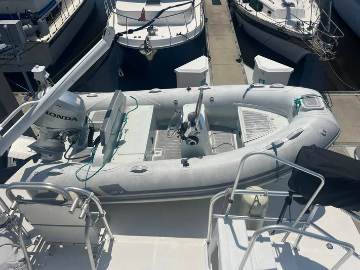 Bazan Yacht Photos Pics Inflatable boat with Honda motor on Great Harbour GH47, 2001 model, docked at marina.