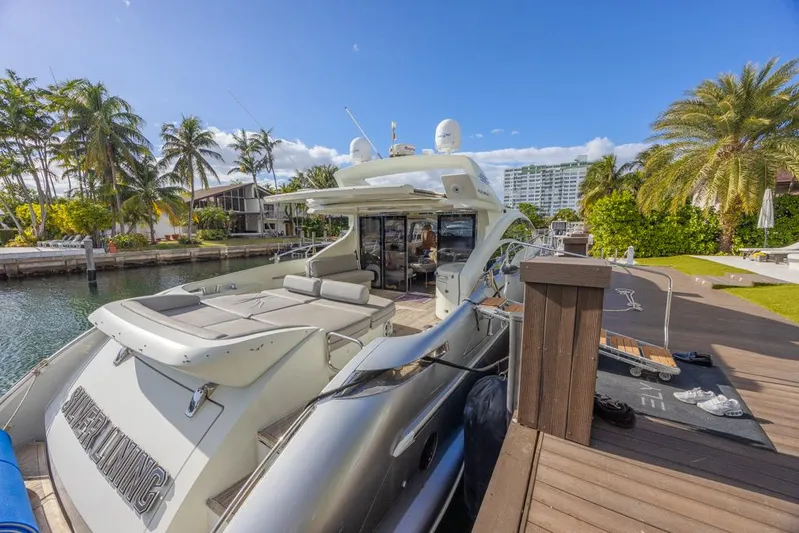  Yacht Photos Pics 2009 Azimut 68S yacht docked in a tropical marina with palm trees.