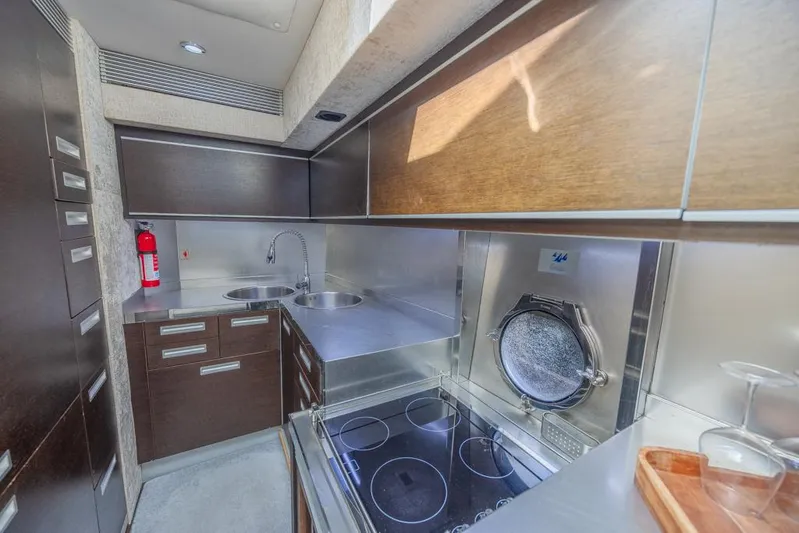  Yacht Photos Pics Modern kitchen interior of 2009 Azimut 68S yacht with sleek cabinetry and appliances.