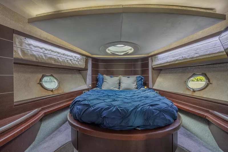  Yacht Photos Pics Luxurious bedroom interior of 2009 Azimut 68S yacht with circular bed and porthole windows.