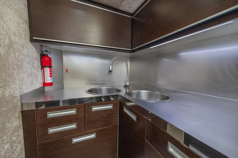  Yacht Photos Pics Modern kitchen area in 2009 Azimut 68S yacht with stainless steel countertops and dual sinks.