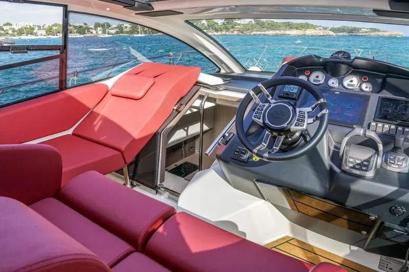 Yacht Photos Pics Interior of 2022 Cranchi M44HT yacht with red seating and modern helm controls.