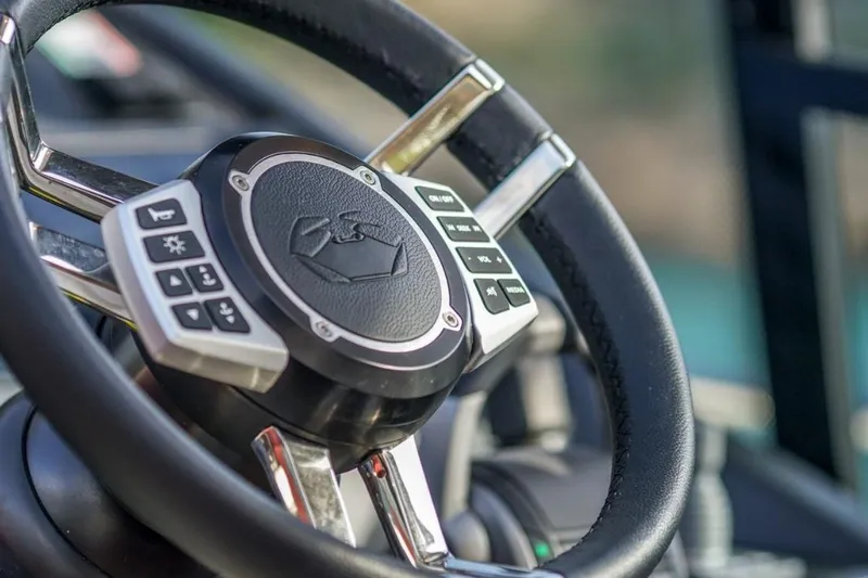  Yacht Photos Pics Steering wheel of 2022 Cranchi M44HT yacht with control buttons.