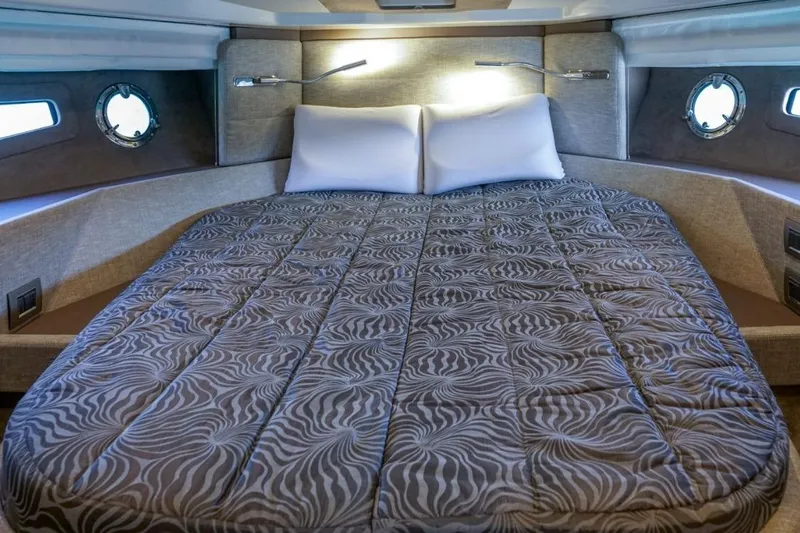  Yacht Photos Pics Luxurious 2022 Cranchi M44HT yacht cabin with elegant bedding and modern lighting.