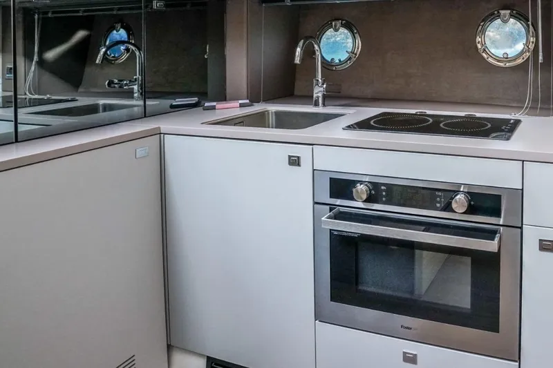  Yacht Photos Pics Modern kitchen in 2022 Cranchi M44HT yacht with oven, stove, and sink.
