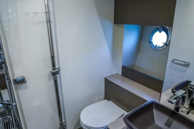  Yacht Photos Pics Modern bathroom in 2022 Cranchi M44HT yacht with shower and porthole window.
